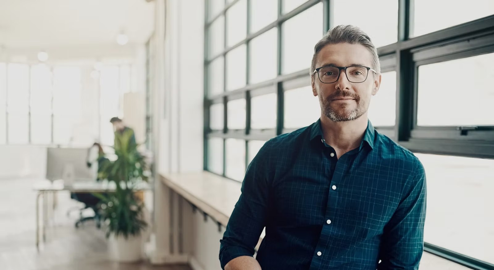Business owner in a modern office, working with Thriver Finance to arrange business finance